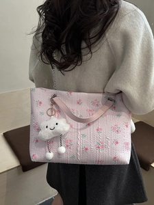 Pink floral tote bag with rose patterns and cloud charm shown from a back-view perspective