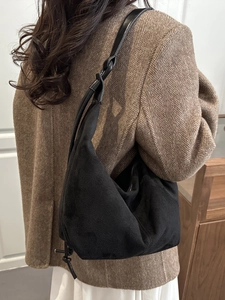 Fashionable black matte suede crescent tote bag with elegant drawstring knot detail