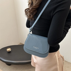 Chic blue-grey crossbody flap bag with fashion trend typography and thin adjustable strap