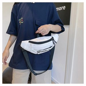 Detail of white nylon waist bag featuring black zipper and adjustable wide strap on model