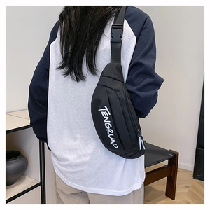 Detail of black nylon chest bag with TENGRUN logo and adjustable buckle strap