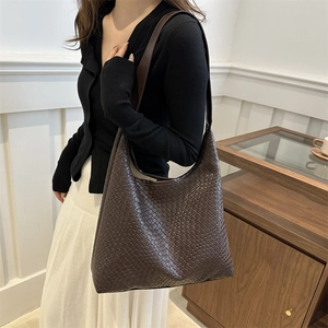 Retro dark brown woven tote bag with a spacious interior and wide shoulder strap