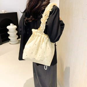 Minimalist beige pleated tote bag with rhinestone details and ruffled shoulder strap