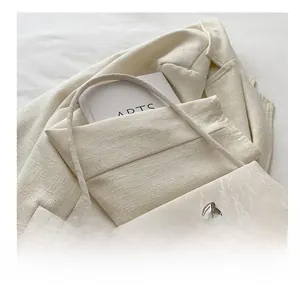 Detailed close-up of marble texture on beige shoulder bag with silver bow buckle