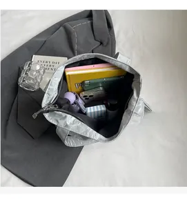 Macro view of metallic silver tote bag interior showing spacious capacity for daily essentials