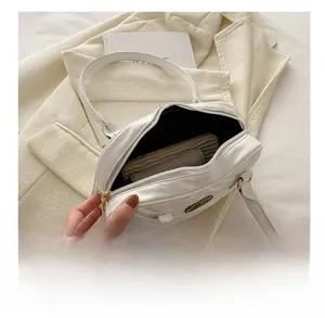 Top view of white quilted shoulder bag showing interior capacity and black lining detail