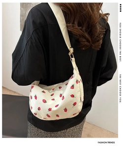 White corduroy strawberry pattern shoulder bag shown on model for size reference