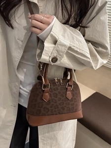 Retro leopard print shell crossbody bag with dark brown leather trim and golden hardware