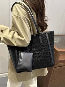 Retro leopard print tote bag with small pouch shown on model in a minimalist setting
