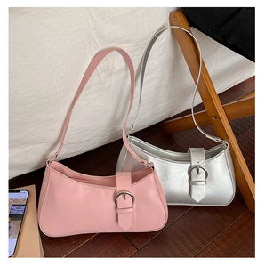 Detail shot of stylish pink and metallic silver crescent underarm bags with silver buckles
