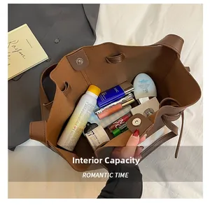 Top view of large brown tote bag interior with magnetic closure and daily cosmetics