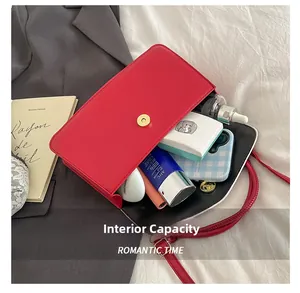 Detail view of large red crossbody bag interior with cosmetics and phone storage space