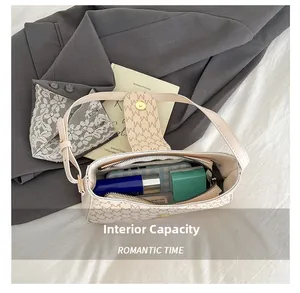 Interior view of monogram shoulder bag showing capacity for phone and cosmetics