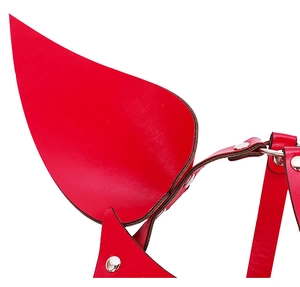 Detail of red leather fox mask featuring metallic rivets and adjustable buckle straps