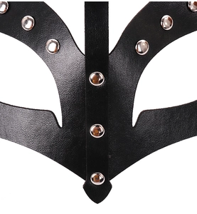 Detail shot of black faux leather texture with silver metal rivets on fox mask