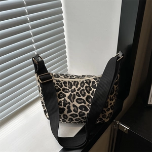 Chic leopard print crossbody crescent bag with wide nylon strap and gold hardware
