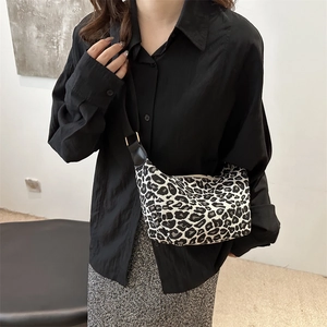 Fashionable leopard print crescent crossbody bag with adjustable black strap for women