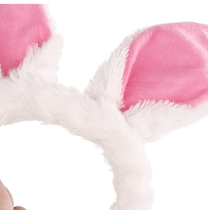 Close-up of plush white and pink rabbit ear headband showing soft faux fur texture