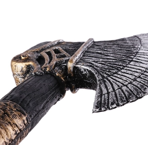 Macro detail of battle axe prop showing weathered metal texture and ornate engravings
