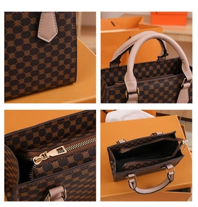 Detail view of brown vintage plaid tote bag with golden hardware and interior compartments