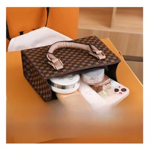 Interior view showing the storage capacity for cosmetics and phone in a vintage handbag