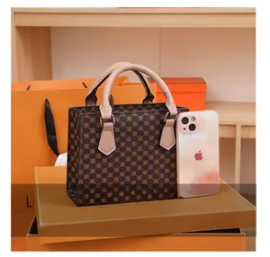 Mini tote bag with vintage geometric print shown next to a smartphone for size reference