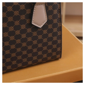 Detailed macro view of retro monogram pattern on textured brown tote bag exterior
