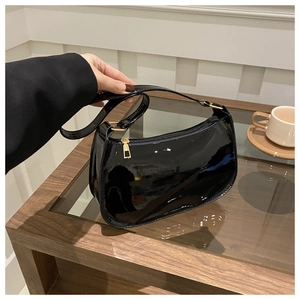 Détail du sac épaule en cuir verni noir brillant avec élégante fermeture éclair dorée