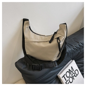 Detail of khaki nylon crescent bag with durable black woven zipper and adjustable strap