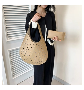 Detailansicht der khakifarbenen Hobo-Tasche mit Metallösen und kleiner Innentasche