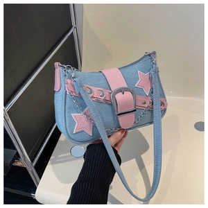 Detail of Y2K denim shoulder bag featuring pink star patches and silver chain accents