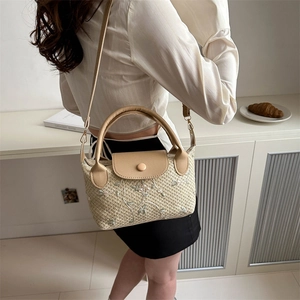 French style beige straw handbag with floral embroidery and leather strap in soft lighting