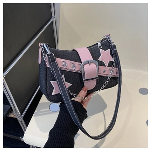 Detailed shot of Y2K denim shoulder bag with pink leather stars and metal chain strap