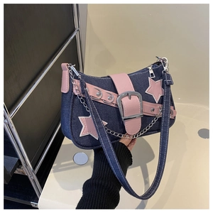 Detail of star patches and silver chain on a pink and denim patchwork shoulder bag