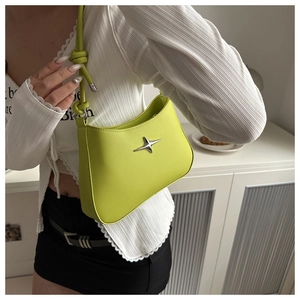 Close-up of bright green crescent shoulder bag with star logo and knotted strap detail