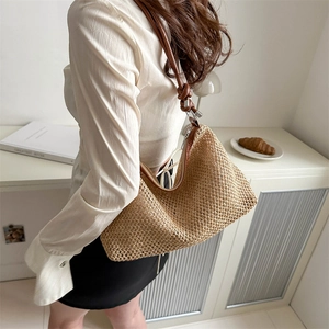Vintage woven straw tote bag with brown leather straps and metal buckles for women