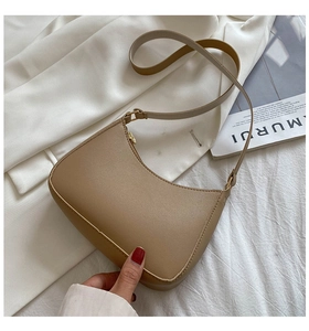 Classic camel faux leather hobo bag with gold hardware on a stylish magazine background