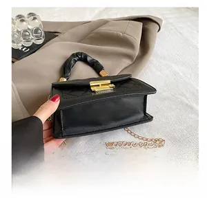 Detail view of the durable base on this black quilted PU leather crossbody handbag