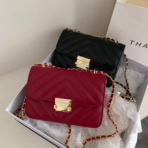 Quilted crossbody bags in black and red with gold chain straps and metal locks