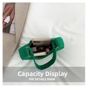 Top view of emerald green felt handbag showing capacity for phone and cosmetics