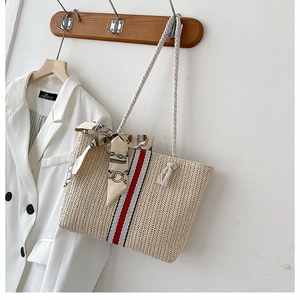 Colorful striped straw tote bag with cotton rope handles and decorative silk scarf