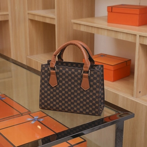 Vintage brown geometric pattern tote bag with caramel leather handles and metal hardware