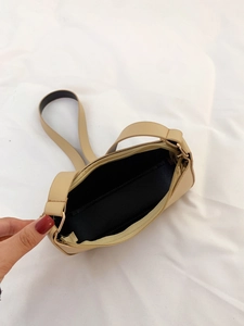 Vista dettagliata dell'interno della borsa beige con fodera nera e trama in pelle PU liscia