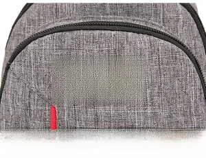 Detail of grey fabric texture with black Fashion Instinct label and red accent strap