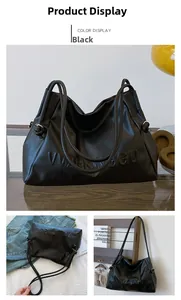 Detalle del bolso tote de cuero PU negro con logo en relieve y correas dobles de hombro