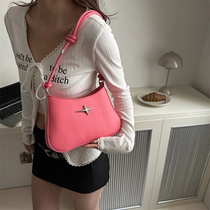 Hot pink shoulder bag with silver star buckle and knotted strap in Y2K style