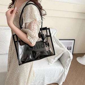 Stylish clear PVC tote bag with black trim and inner pouch for women's fashion use