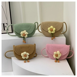 Close-up of colorful woven flower crossbody bags showing knit texture and floral details