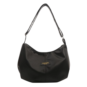 Fashionable black faux leather crescent tote bag with adjustable shoulder strap and gold text