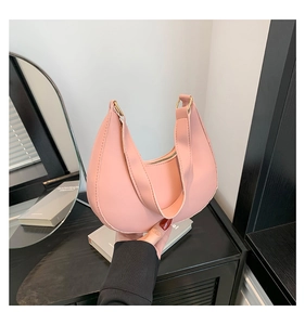 Detail view of pink hobo bag with litchi grain texture and gold metal buckle hardware